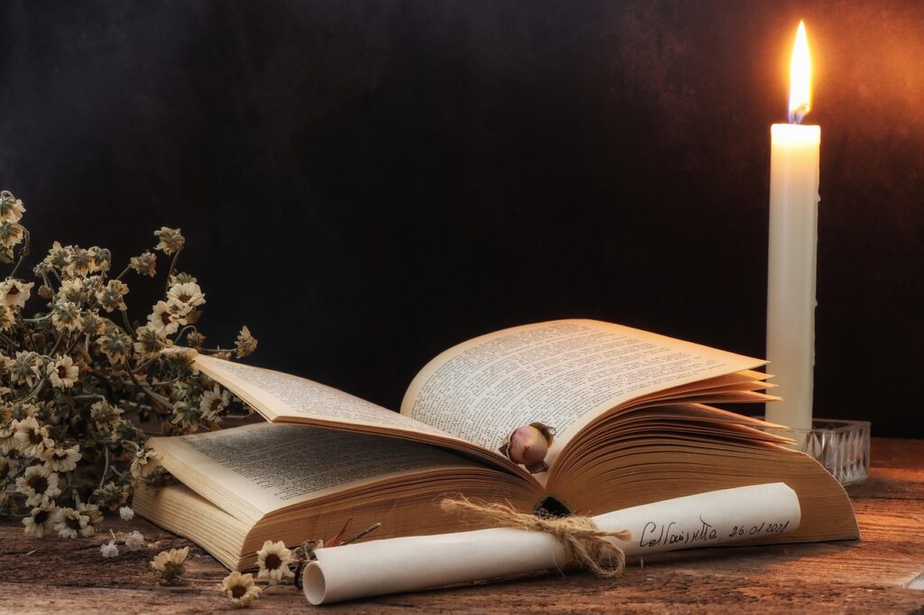 Historical fiction book with candle, flowers, and rolled up parchment.