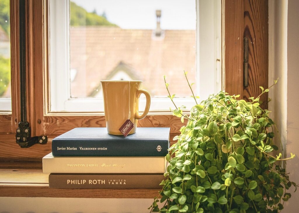 Book stack with a cup of tea on top.