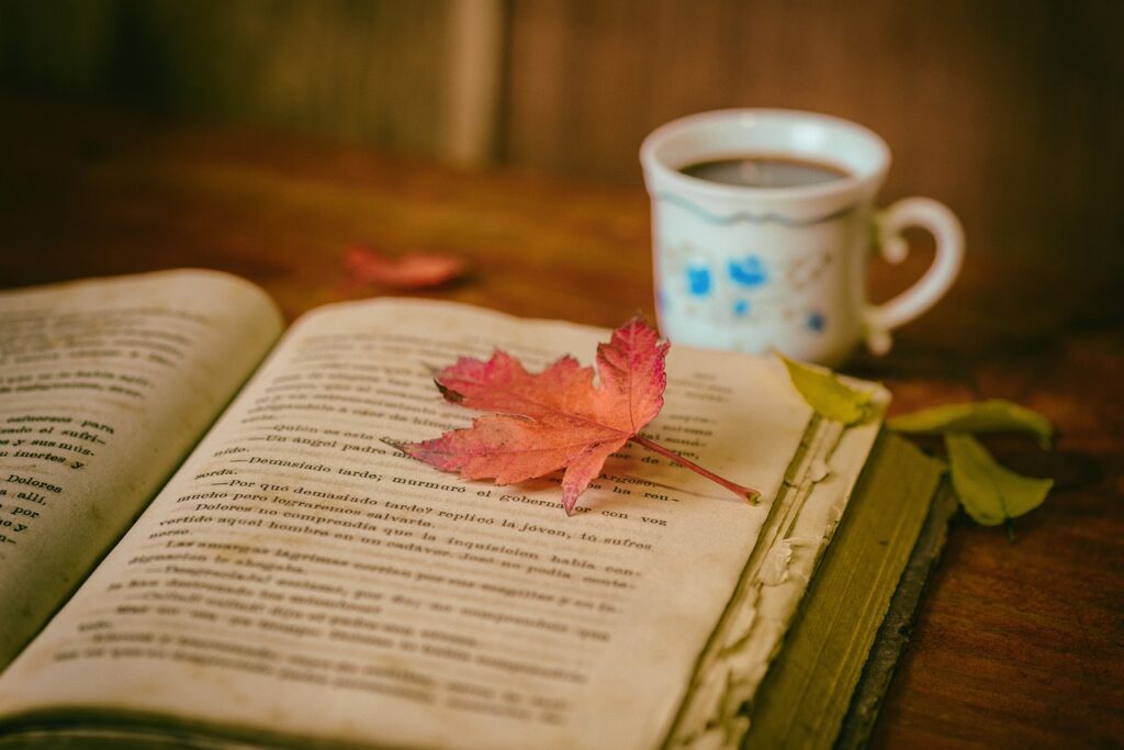 Book with leaves and coffee.